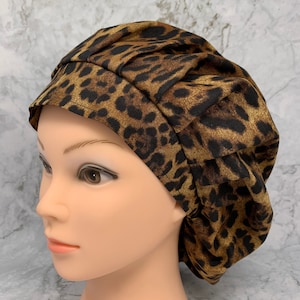 May include: A brown and black leopard print surgical scrub hat with a gathered top.
