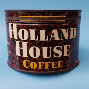 May include: A vintage metal coffee can with a brown background and a pattern of coffee beans. The can has white lettering that reads "HOLLAND HOUSE COFFEE".