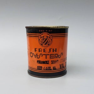 May include: A vintage metal can of fresh oysters from the Pocomoke Sound in Deep Creek, VA. The can is orange with black lettering and a crest.