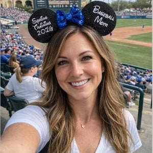 May include: A white ceramic mug with a black handle and the text "But First, Coffee" in a bold, black font. The mug is set against a blurred background, highlighting its clean design.