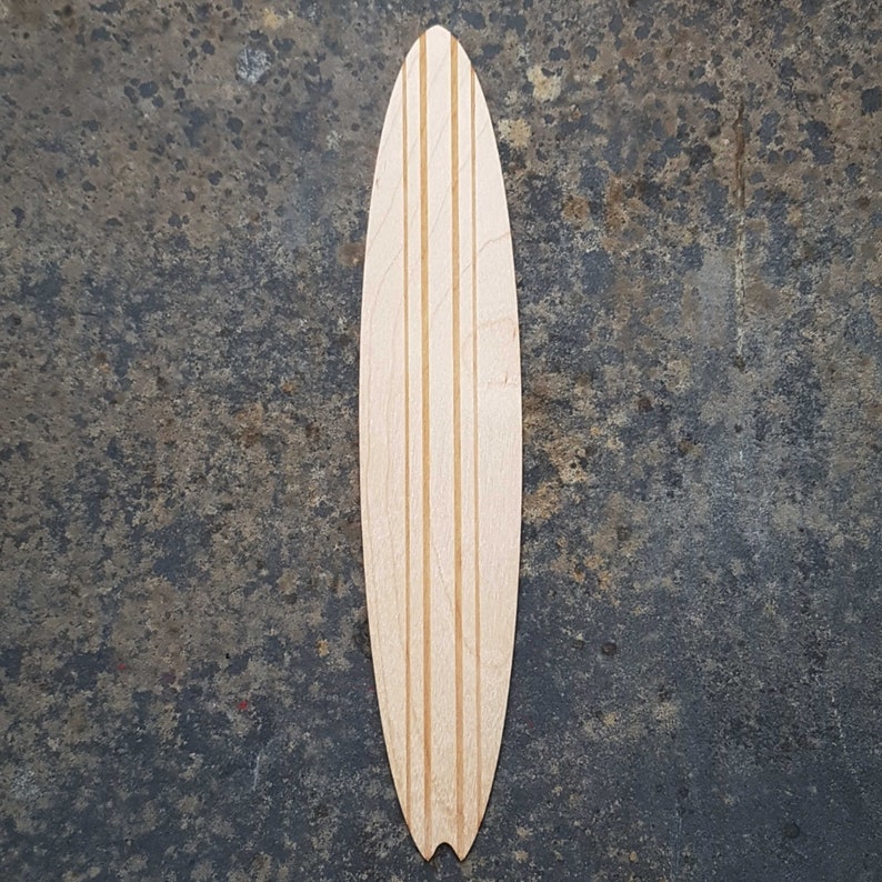 May include: A wooden surfboard blank with three parallel lines running down the center.