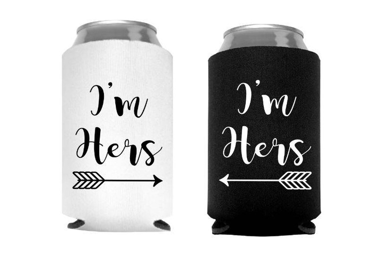 May include: Two can coolers, one white and one black, each with the text "I'm Hers" in a script font, and an arrow graphic. The white cooler has a right-pointing arrow, while the black cooler has a left-pointing arrow.