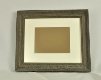 May include: A rustic wood picture frame with a white mat and a brown paper insert. The frame has a distressed wood finish.