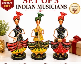May include: A set of three metal figurines depicting Indian musicians, each wearing a colorful turban and traditional attire. The figures are playing a stringed instrument, a flute, and a drum, all mounted on circular black bases with painted details.