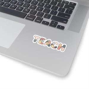 May include: A sticker featuring the word "TEACH" in a patchwork design. The letters are made from various fabric patterns in pastel shades, including blue, yellow, and peach. The sticker is on a silver laptop.