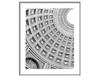 May include: Black and white photograph of a domed ceiling with a circular pattern of squares and circles. The ceiling is made of stone and has a light source in the center.