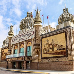 May include: The World's Only Corn Palace in Mitchell, South Dakota, is a building decorated with colorful murals made from corn, grains, and seeds. The building has a large sign that reads "World's Only Corn Palace" and a smaller sign that reads "South Dakota Home Grown".