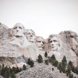 May include: A close-up view of Mount Rushmore National Memorial, featuring the carved faces of four U.S. presidents: George Washington, Thomas Jefferson, Theodore Roosevelt, and Abraham Lincoln.