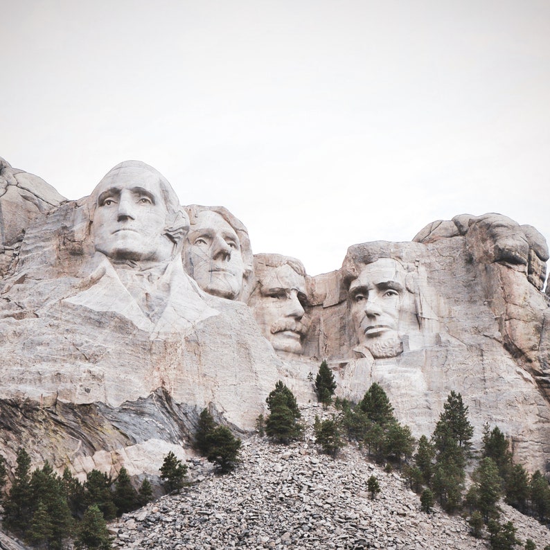 May include: A close-up view of Mount Rushmore National Memorial, featuring the carved faces of four U.S. presidents: George Washington, Thomas Jefferson, Theodore Roosevelt, and Abraham Lincoln.