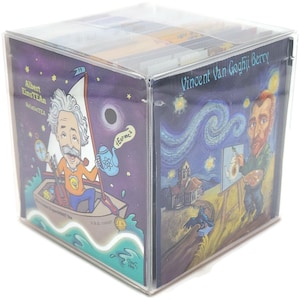 May include: A clear plastic box with a colorful tea box inside. The tea box features a cartoon image of Albert Einstein on a boat with the text "Albert Einstein Relativity TEA" and a cartoon image of Vincent Van Gogh painting a starry night sky with the text "Vincent Van Gogh Fiji Berry".