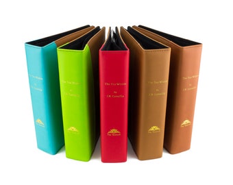 May include: Five hardcover books with different colored covers, turquoise, green, red, brown, and tan. The books are titled "The Tea Within" by "I.N. Camellia".