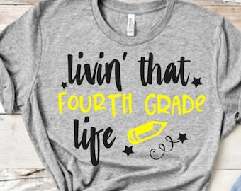 May include: Gray t-shirt with black text that reads "Livin' that Fourth Grade Life" with a yellow pencil and stars.