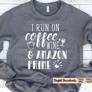 May include: Gray sweatshirt with white text that reads "I run on coffee, wine, & Amazon Prime" with a coffee cup, wine glass, and heart graphic.