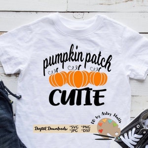 May include: White t-shirt with a black graphic that says "pumpkin patch cutie" with three orange pumpkins. The graphic also includes the text "DD by Artsy Walls" and "Digital Downloads: SVG PNG JPG DXF".