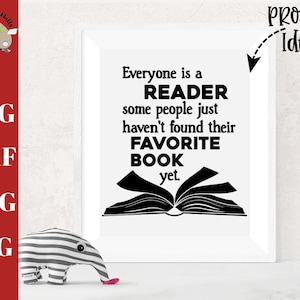 May include: A white framed print with black text that reads "Everyone is a READER some people just haven't found their FAVORITE BOOK yet."  A black silhouette of an open book is below the text. The text "Project Idea" is written in black above the frame.