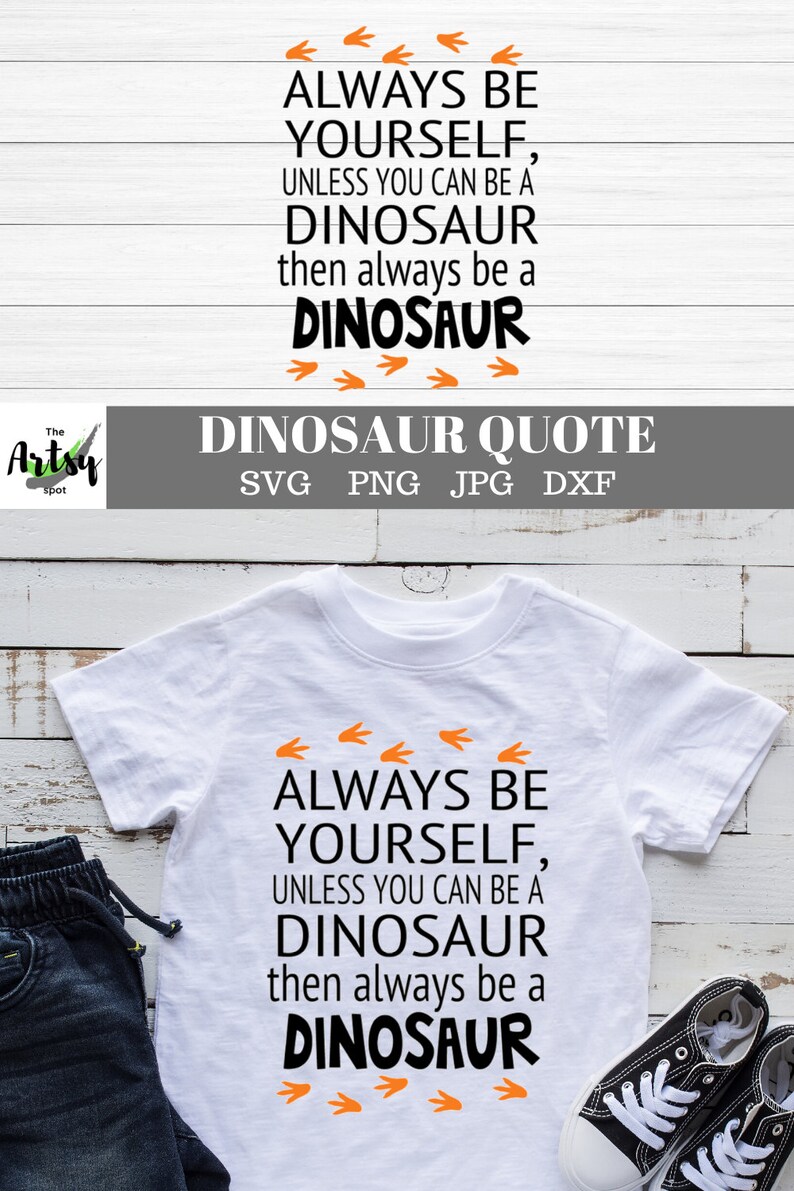 May include: A white t-shirt with a black graphic that reads "Always be yourself, unless you can be a dinosaur, then always be a dinosaur." The graphic is surrounded by orange dinosaur footprints.