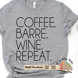 May include: A gray t-shirt with the text "COFFEE. BARRE. WINE. REPEAT." printed in black. The text is centered on the shirt. The shirt is on a white background. There are two dumbbells and a pair of sneakers on the background.