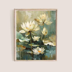 May include: A framed painting of white lotus flowers with yellow centers and green lily pads. The artwork has a textured, impressionistic style with a muted color palette of greens, blues, and creams. The frame is a light wood color.