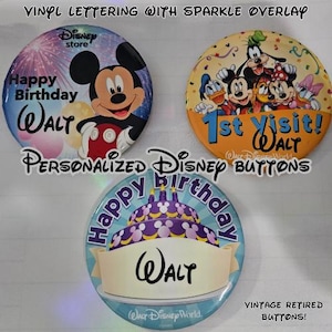 May include: Three round Disney buttons featuring personalized vinyl lettering with a sparkle overlay. One button shows Mickey Mouse, another displays various Disney characters with the text 1st visit! Walt, and the third shows a birthday cake with the name Walt.