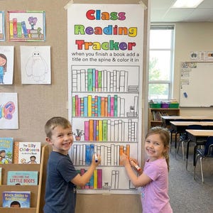 May include: A vertical paper Class Reading Tracker poster with a bookshelf illustration. The text reads Class Reading Tracker when you finish a book add a title on the spine & color it in. The shelves contain outlines of books, some colored in.