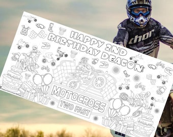 May include: A black and white coloring page featuring a motocross themed birthday party. The page includes a birthday cake, balloons, presents, and a motocross rider. The text "Happy 2nd Birthday Deacon" and "Motocross Two Fast" are included on the page.