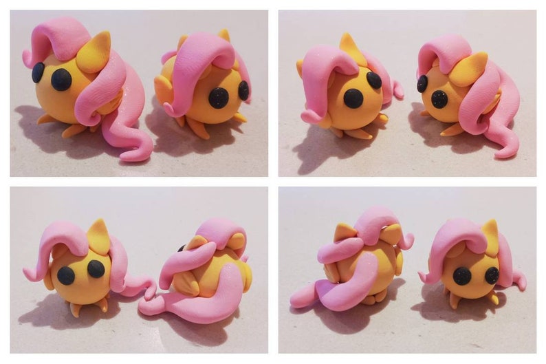 May include: Four images of handmade clay figurines. Each figurine is yellow with pink hair and black eyes. The figurines are in various poses, some standing and some lying down. The overall theme is a cartoon character.