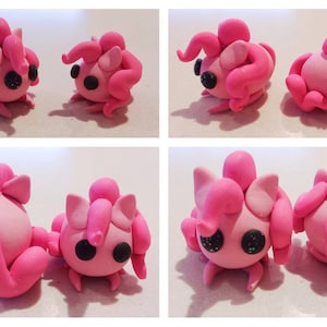 May include: A collection of four images showcasing two handmade pink clay figures. Each figure has a rounded body, small legs, and large, expressive black eyes. The figures have various curled appendages and a topknot.