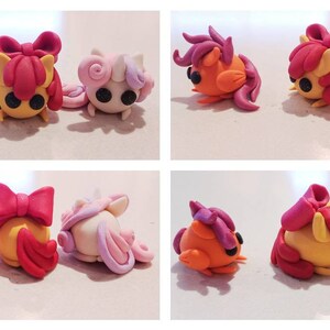 May include: A collection of handmade clay figurines in the shape of cartoon ponies. The ponies are in various poses and feature orange, yellow, pink, and purple colors. Each pony has black eyes and a unique hairstyle.