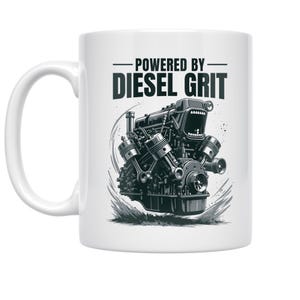 May include: White ceramic mug featuring a black and gray illustration of an engine with the text "POWERED BY DIESEL GRIT". The engine design has pistons, a turbocharger, and a smiling face.