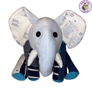 May include: A blue and white stuffed elephant toy with a striped body and blue and white patterned ears. The elephant has black button eyes and a white trunk.