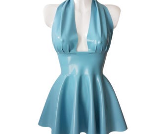 May include: A light blue halter dress with a flared skirt is displayed on a white mannequin. The dress has a shiny, smooth texture and a deep V-neckline. The dress is a solid color and has a classic silhouette.