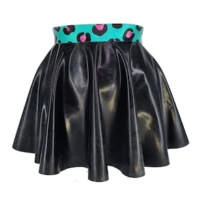 Peut inclure: Une jupe courte évasée noire et brillante avec une ceinture à imprimé léopard turquoise et rose.