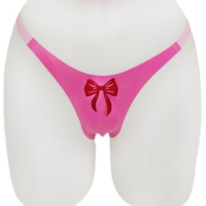 May include: Pink lingerie with a red bow detail.