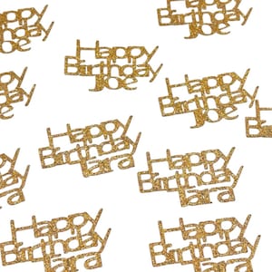 May include: Gold glitter confetti with the words "Happy Birthday" and the names "Joe" and "Tara" on each piece.