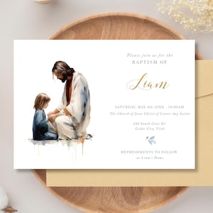 May include: A watercolor illustration of a man and a child. The man is wearing a white robe and the child is wearing a blue dress. The text on the card reads "Please join us for the Baptism of Liam. Saturday, May 4th, 20XX - 10:00 AM. The Church of Jesus Christ of Latter-day Saints. 280 South Cove Dr. Cedar City, Utah. Refreshments to follow at Liam's Home."