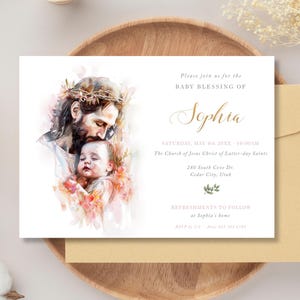 May include: A baby blessing invitation with a watercolour illustration of Jesus and a baby. The invitation includes the name "Sophia", event details, and a gold envelope. The design is soft and elegant.
