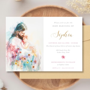 May include: Baby blessing invitation featuring a watercolor illustration of Jesus holding a baby, surrounded by flowers. The invitation includes the name "Sophia" in elegant script, along with event details and a floral accent.