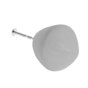 May include: A grey ceramic knob with a silver screw. The knob is round and has a smooth surface.