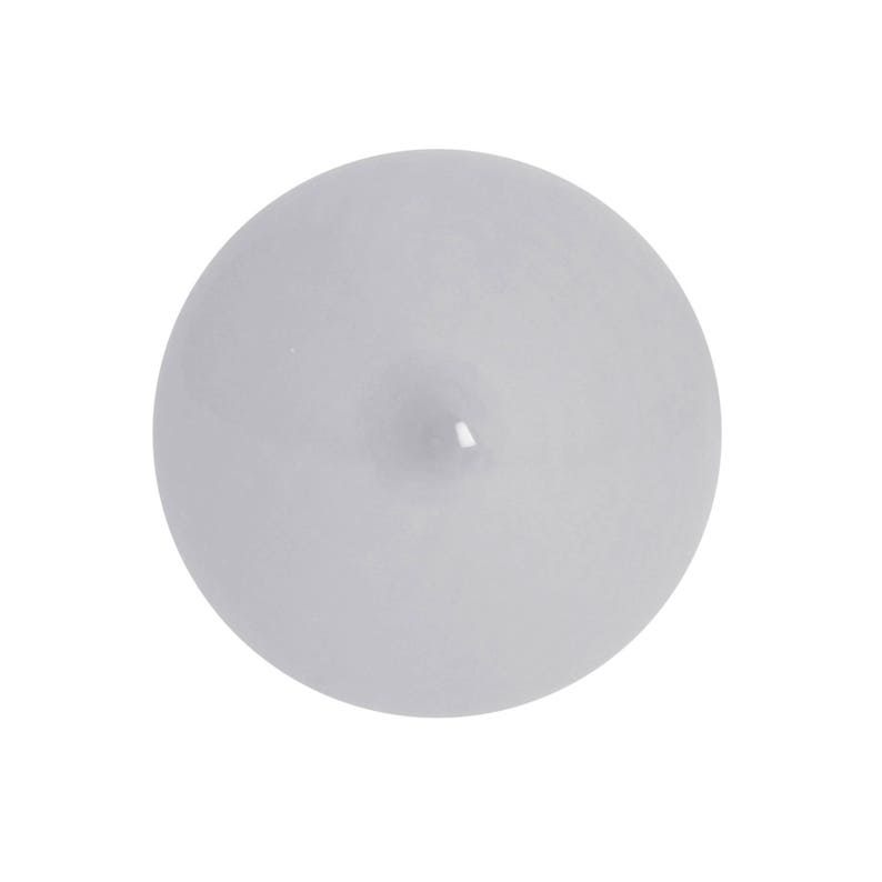 May include: A single, round, white candle with a slight indentation on top.