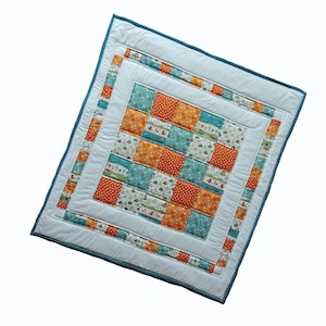 Patchwork baby quilt or play mat featuring autumn colours, foxes and trees