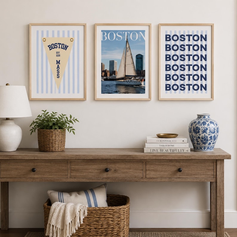 Boston wall art set of 3 featuring a vintage Boston pennant print, Boston sailboat skyline photography, and blue striped Boston typography poster in light wood frames.