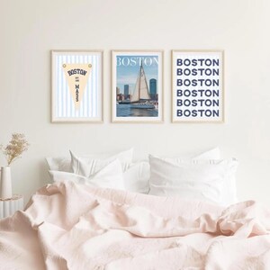 Boston wall art set of 3 featuring a vintage Boston pennant print, Boston sailboat skyline photography, and blue striped Boston typography poster in light wood frames.