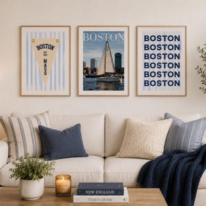 Boston wall art set of 3 featuring a vintage Boston pennant print, Boston sailboat skyline photography, and blue striped Boston typography poster in light wood frames.