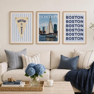 Boston wall art set of 3 featuring a vintage Boston pennant print, Boston sailboat skyline photography, and blue striped Boston typography poster in light wood frames.