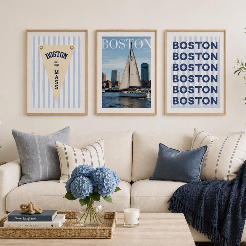 Boston wall art set of 3 featuring a vintage Boston pennant print, Boston sailboat skyline photography, and blue striped Boston typography poster in light wood frames.