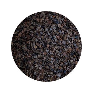 May include: A close-up image of a pile of dark brown buckwheat groats.