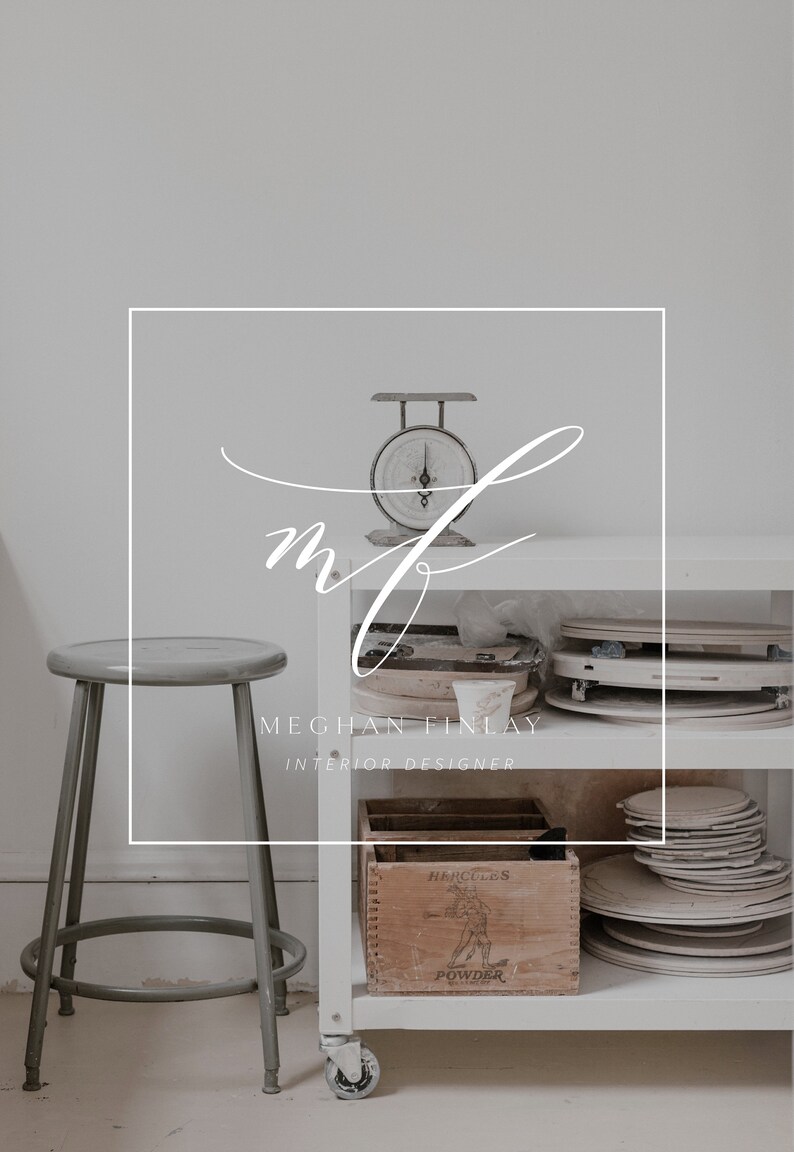 May include: A white shelving unit with a vintage scale, a wooden box labelled "Hercules Powder", and stacks of ceramic plates. The shelving unit is in a white room with a grey stool.