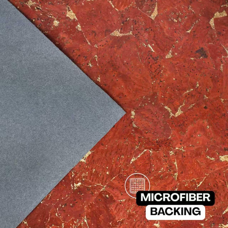 May include: A sheet of red cork fabric with a natural textured pattern and gold-colored metallic flecks throughout. A triangular section of the material is folded back to reveal a solid gray microfiber backing with the text MICROFIBER BACKING.