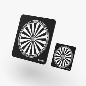 May include: Two black rectangular focus puller markers with rounded corners. Each features a central white and black sunburst pattern surrounded by a circular border containing the text DO NOT DISTURB - FOCUS PULLER AT WORK and a small logo.