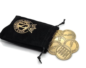 May include: A black velvet pouch with a gold logo that reads "King Solomon Coin" and a set of eight gold-colored metal coins with various symbols and designs.